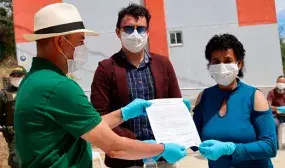 Rosa Emilia Cañas recibe los documentos que la acreditan como nueva propietaria de vivienda en San Lorenzo, Nariño. Foto: Cortesía Alcaldía de San Lorenzo.